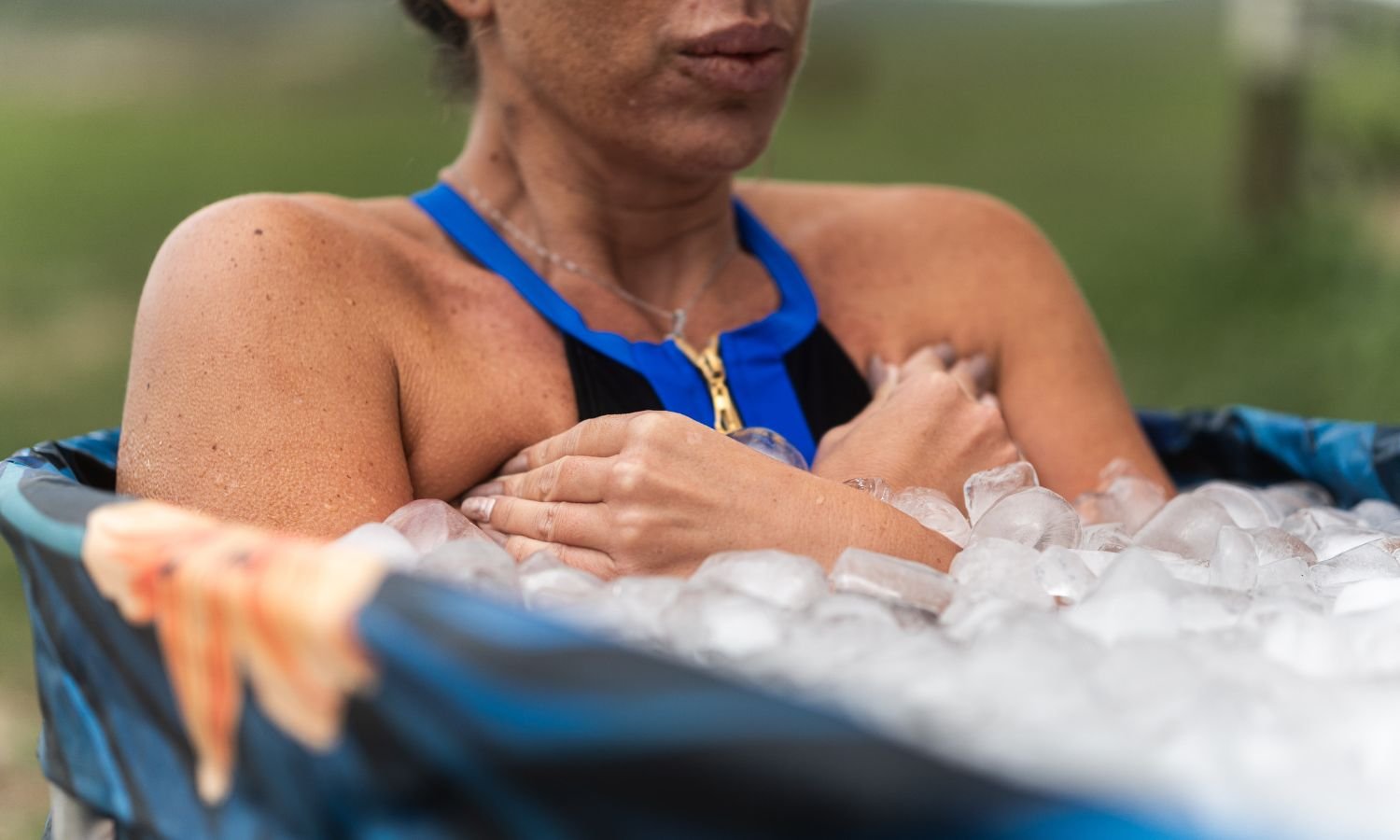 female athlete taking ice bath after workout